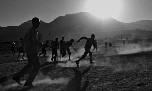Afghan children playing soccer in front of the ruined Darul Aman Palace on the outskirts of Kabul from www.dawn.com/news/1050835